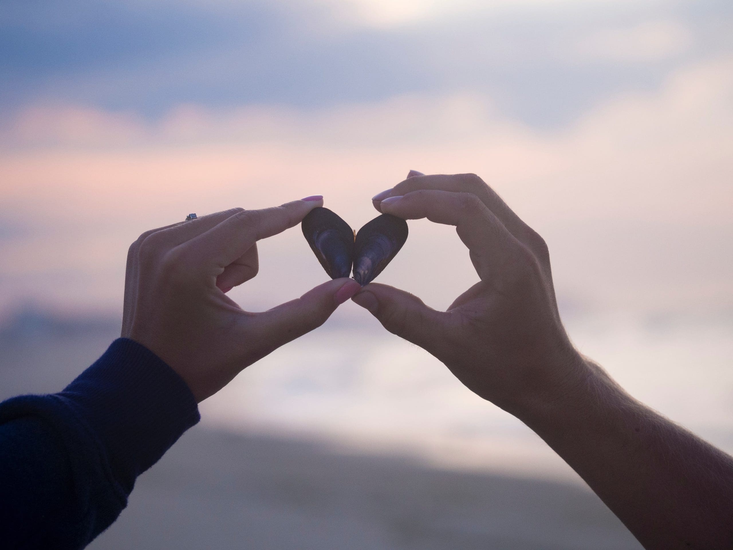 hands holding matching rocks from the beach