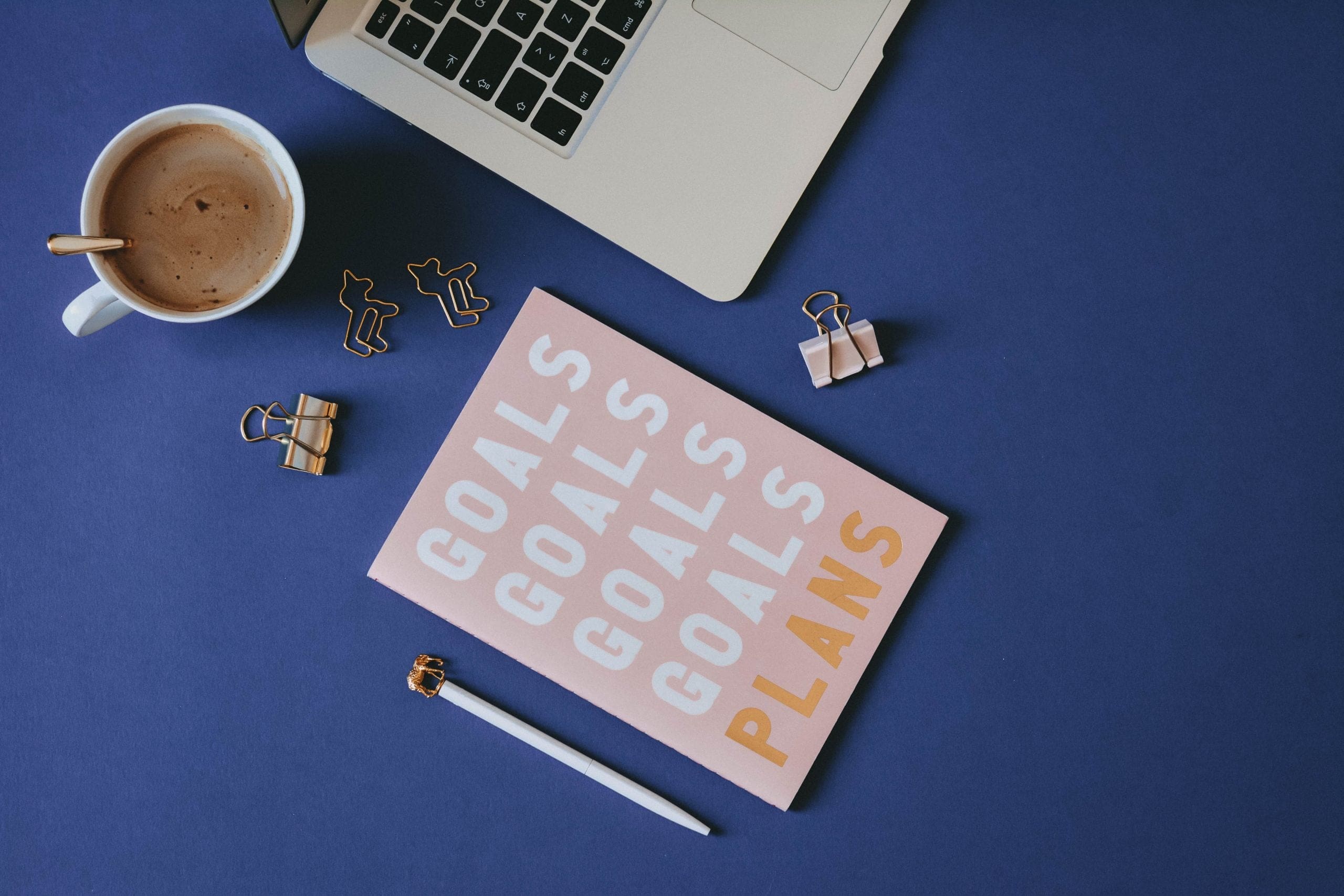 project planner on desk with coffee mug